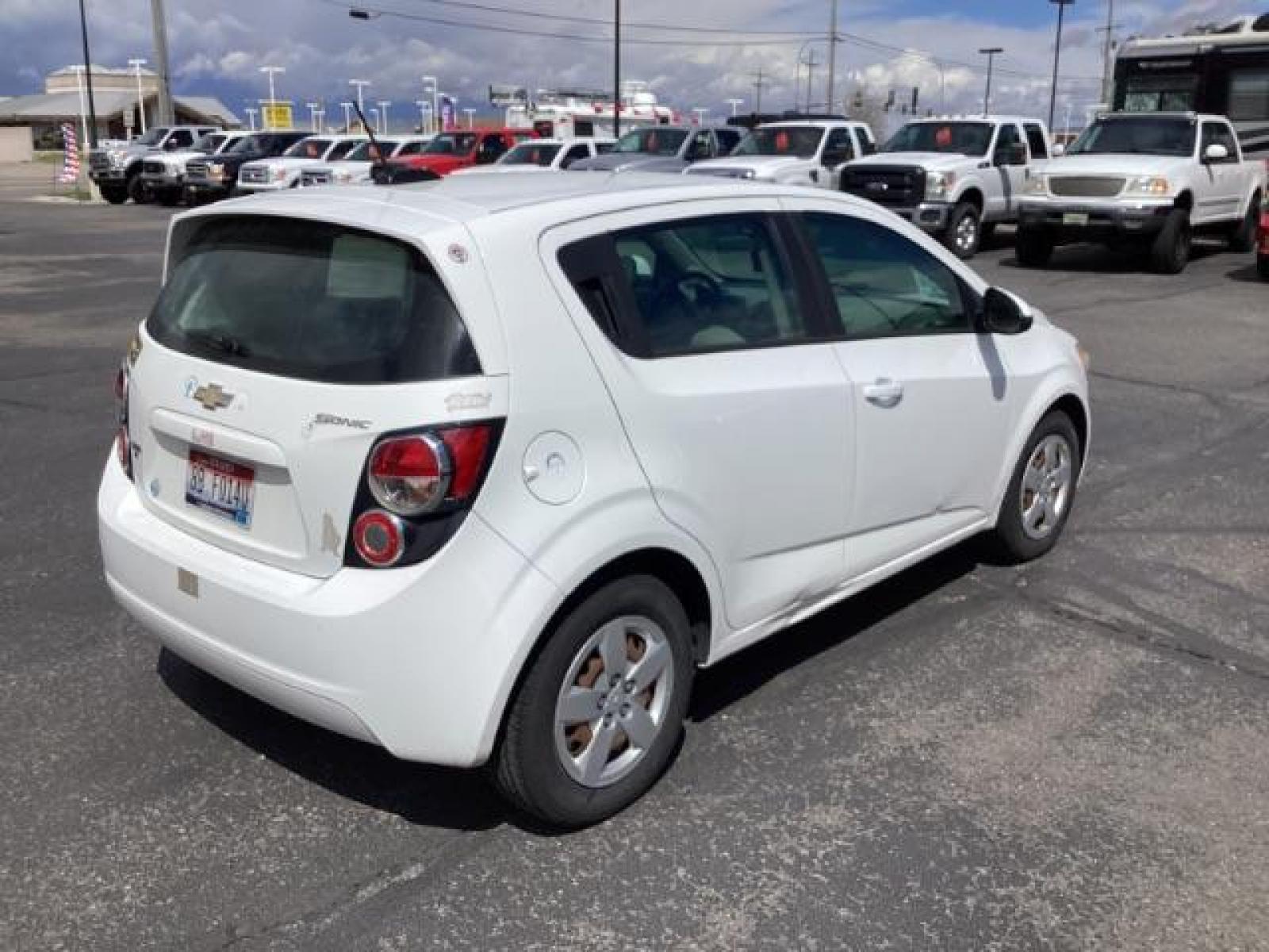 2016 Summit White Chevrolet Sonic LS Auto 5-Door (1G1JA6SH6G4) with an 1.8L L4 DOHC 24V engine, 6-Speed Automatic transmission, located at 1235 N Woodruff Ave., Idaho Falls, 83401, (208) 523-1053, 43.507172, -112.000488 - Photo #4