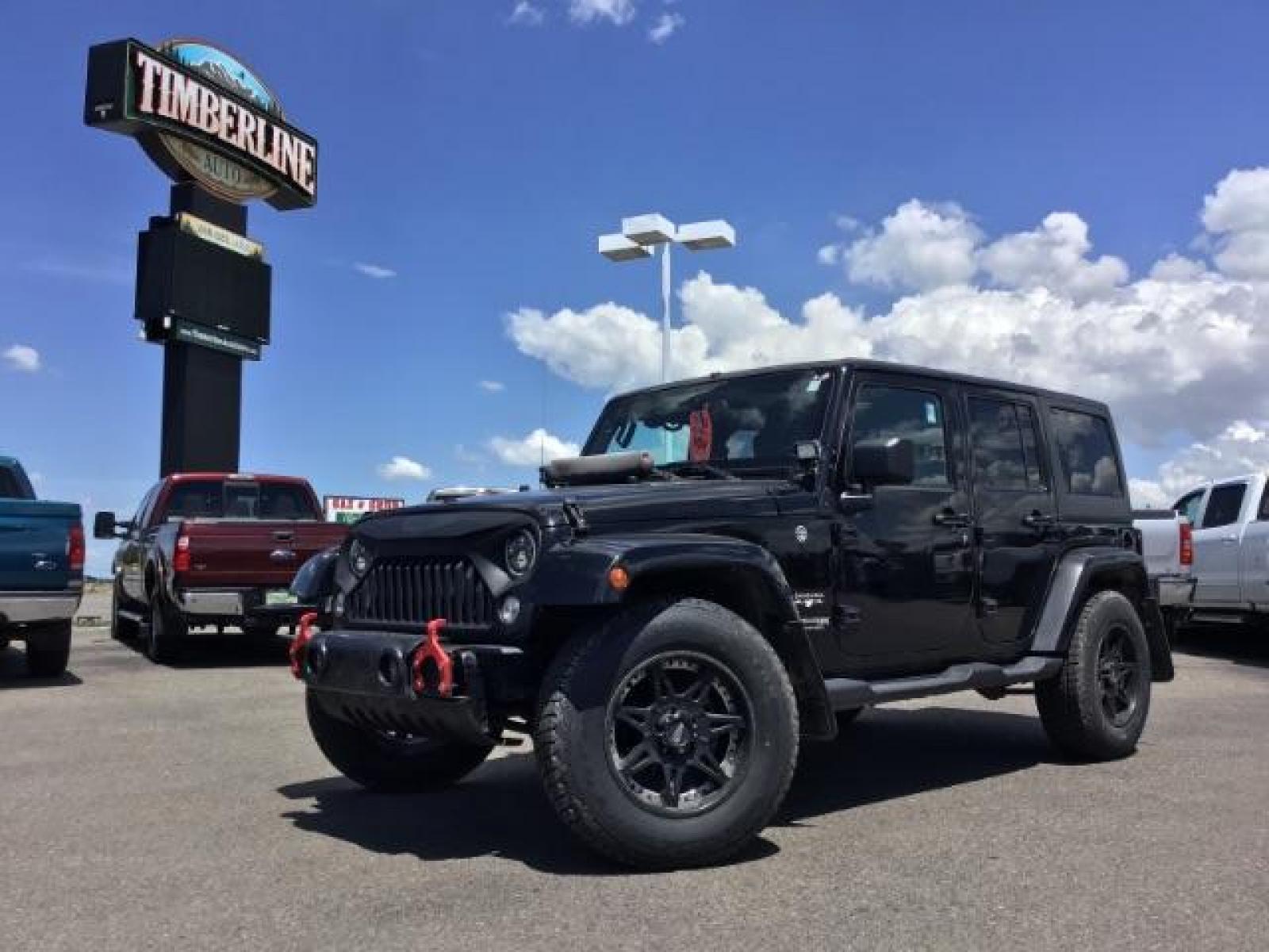 2018 Black Clear Coat /Black, cloth Jeep Wrangler JK Unlimited Sahara 4WD (1C4BJWEG8JL) with an 3.6L V6 DOHC 24V FFV engine, 6-Speed Automatic transmission, located at 1235 N Woodruff Ave., Idaho Falls, 83401, (208) 523-1053, 43.507172, -112.000488 - This Jeep is in very good condition and has a few aftermarket parts like the Angry Jeep Face grill replacement, MOTO METAL wheels, light pods, light bars, aftermarket front bumper, head lights, and tail lights. Inside you'll see the clean Sahara premium seats, a large infotainment screen, the ALPINE - Photo #0