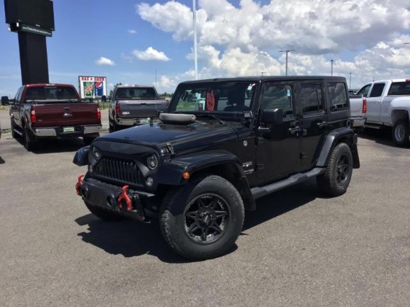2018 Black Clear Coat /Black, cloth Jeep Wrangler JK Unlimited Sahara 4WD (1C4BJWEG8JL) with an 3.6L V6 DOHC 24V FFV engine, 6-Speed Automatic transmission, located at 1235 N Woodruff Ave., Idaho Falls, 83401, (208) 523-1053, 43.507172, -112.000488 - This Jeep is in very good condition and has a few aftermarket parts like the Angry Jeep Face grill replacement, MOTO METAL wheels, light pods, light bars, aftermarket front bumper, head lights, and tail lights. Inside you'll see the clean Sahara premium seats, a large infotainment screen, the ALPINE - Photo #1