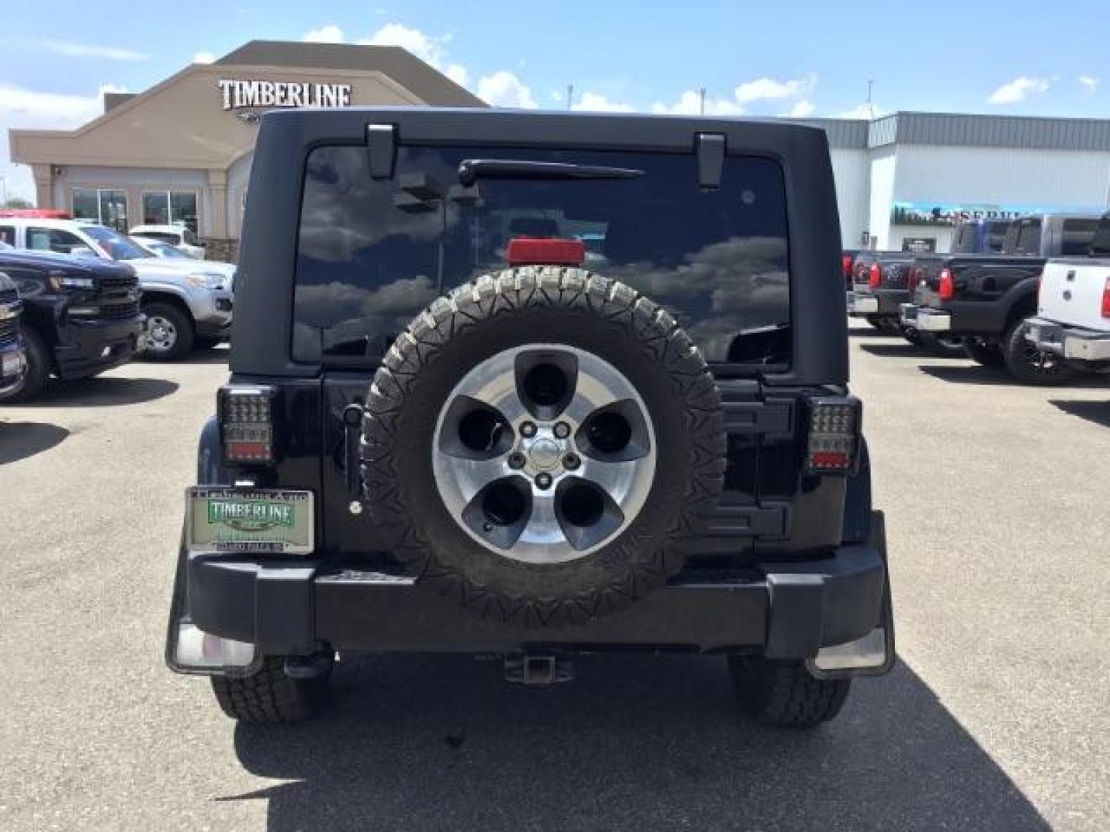 2018 Black Clear Coat /Black, cloth Jeep Wrangler JK Unlimited Sahara 4WD (1C4BJWEG8JL) with an 3.6L V6 DOHC 24V FFV engine, 6-Speed Automatic transmission, located at 1235 N Woodruff Ave., Idaho Falls, 83401, (208) 523-1053, 43.507172, -112.000488 - This Jeep is in very good condition and has a few aftermarket parts like the Angry Jeep Face grill replacement, MOTO METAL wheels, light pods, light bars, aftermarket front bumper, head lights, and tail lights. Inside you'll see the clean Sahara premium seats, a large infotainment screen, the ALPINE - Photo #4