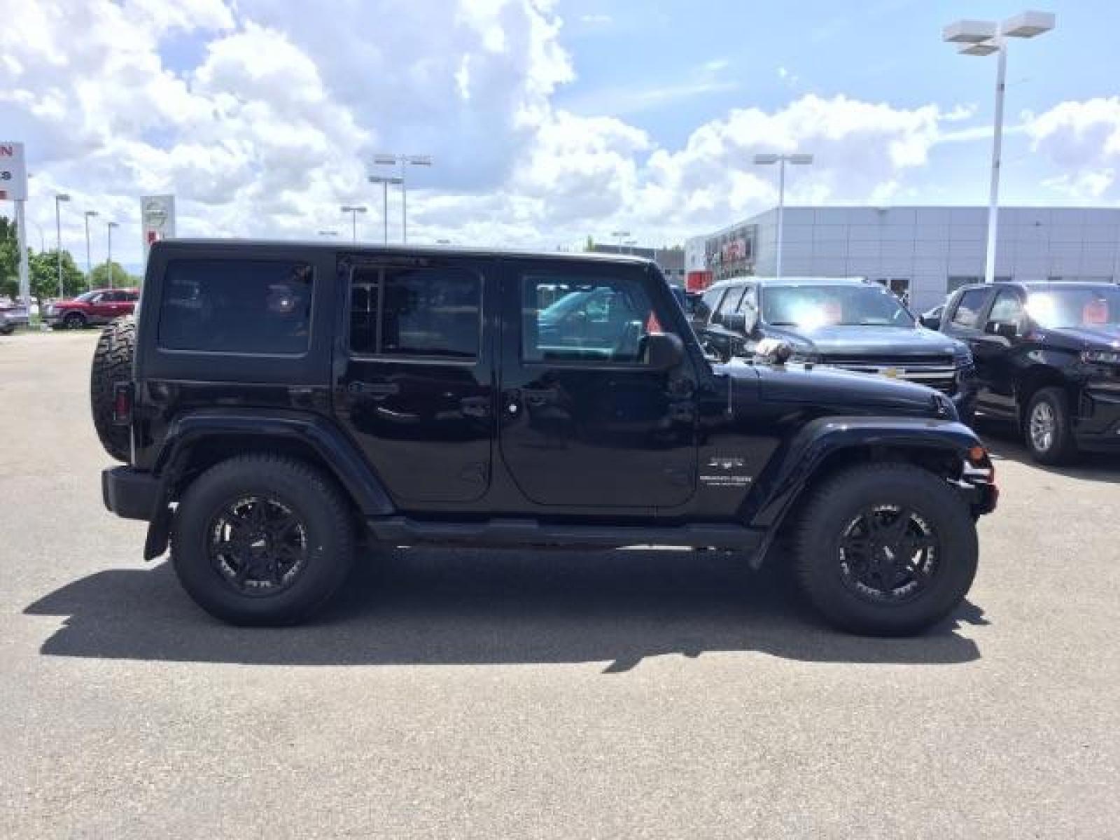 2018 Black Clear Coat /Black, cloth Jeep Wrangler JK Unlimited Sahara 4WD (1C4BJWEG8JL) with an 3.6L V6 DOHC 24V FFV engine, 6-Speed Automatic transmission, located at 1235 N Woodruff Ave., Idaho Falls, 83401, (208) 523-1053, 43.507172, -112.000488 - This Jeep is in very good condition and has a few aftermarket parts like the Angry Jeep Face grill replacement, MOTO METAL wheels, light pods, light bars, aftermarket front bumper, head lights, and tail lights. Inside you'll see the clean Sahara premium seats, a large infotainment screen, the ALPINE - Photo #6