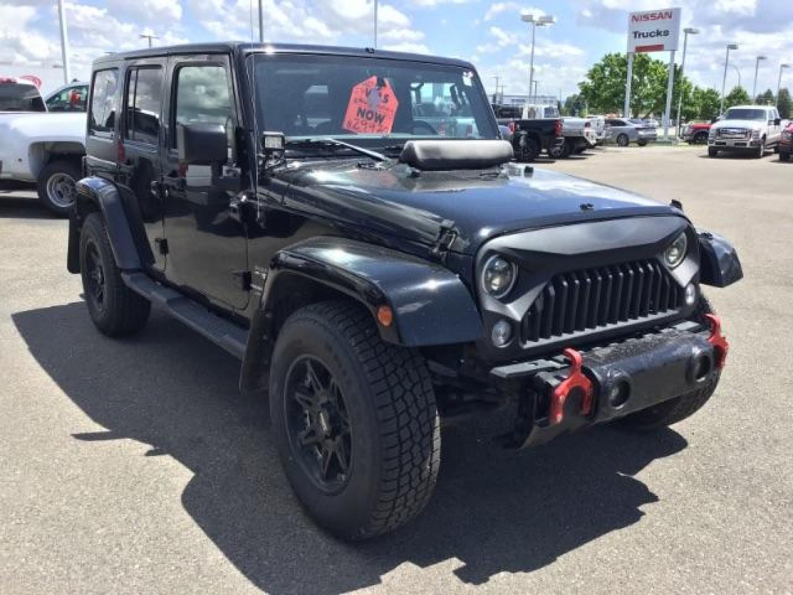 2018 Black Clear Coat /Black, cloth Jeep Wrangler JK Unlimited Sahara 4WD (1C4BJWEG8JL) with an 3.6L V6 DOHC 24V FFV engine, 6-Speed Automatic transmission, located at 1235 N Woodruff Ave., Idaho Falls, 83401, (208) 523-1053, 43.507172, -112.000488 - This Jeep is in very good condition and has a few aftermarket parts like the Angry Jeep Face grill replacement, MOTO METAL wheels, light pods, light bars, aftermarket front bumper, head lights, and tail lights. Inside you'll see the clean Sahara premium seats, a large infotainment screen, the ALPINE - Photo #7