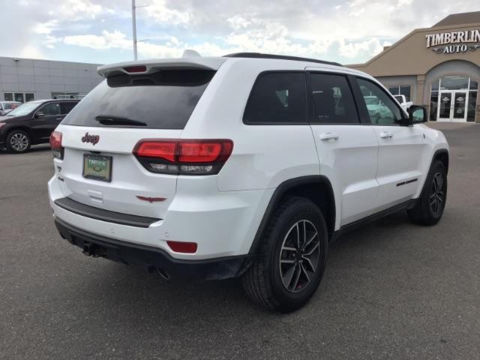 2020 Bright White Clear Coat /Black/Ruby Red, leather Jeep Grand Cherokee Trailhawk 4WD (1C4RJFLG5LC) with an 3.6L V6 DOHC 24V engine, 8-Speed Automatic transmission, located at 1235 N Woodruff Ave., Idaho Falls, 83401, (208) 523-1053, 43.507172, -112.000488 - Leather and loaded, heated and cooled seats, blind spot monitors, AWD, low miles. At Timberline Auto it is always easy to find a great deal on your next vehicle! Our experienced sales staff can help find the right vehicle that will fit your needs. Our knowledgeable finance department has options for - Photo #4