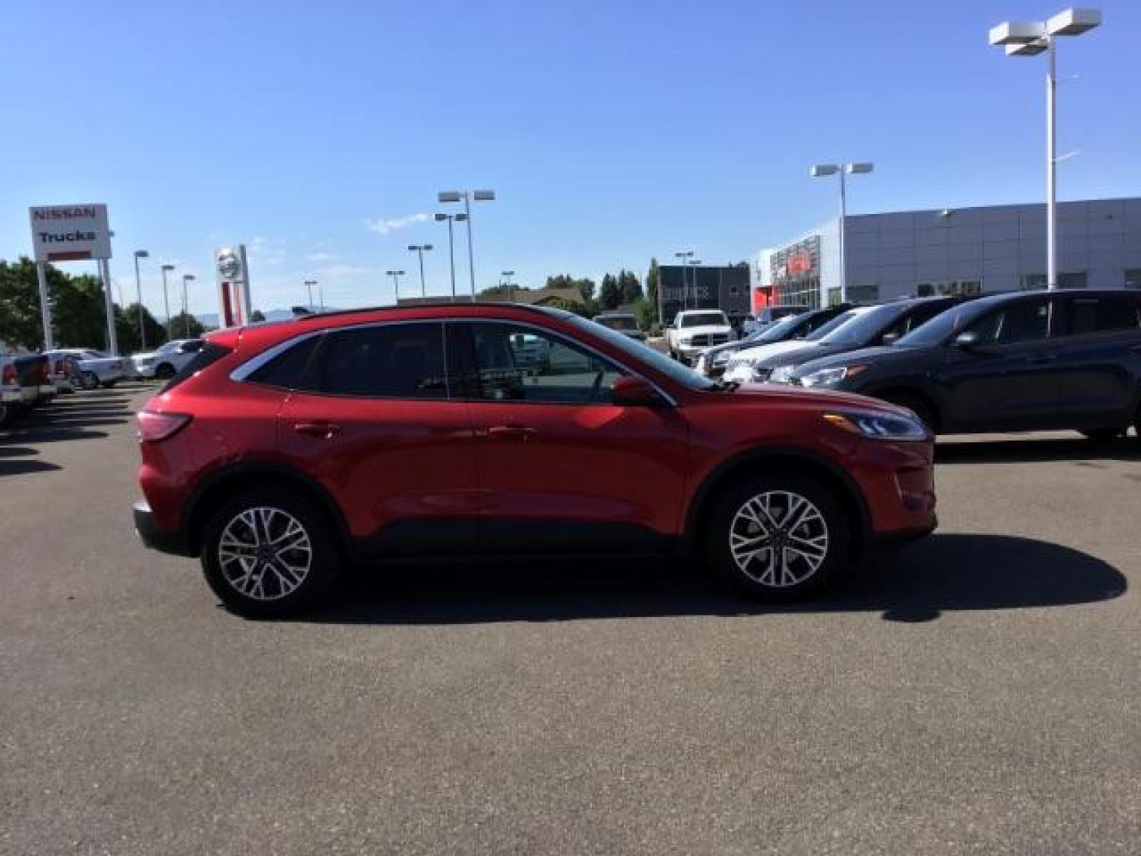 2021 Rapid Red Metallic Tinted Clearcoat /Ebony Ford Escape SEL AWD (1FMCU9H62MU) with an 1.5L L3 engine, 8-Speed Automatic transmission, located at 1235 N Woodruff Ave., Idaho Falls, 83401, (208) 523-1053, 43.507172, -112.000488 - 2021 Ford Escape SEL package with the 1.5L EcoBoost engine, heated seats, remote start, dual moonroof, and so much more! At Timberline Auto it is always easy to find a great deal on your next vehicle! Our experienced sales staff can help find the right vehicle that will fit your needs. Our knowled - Photo #6