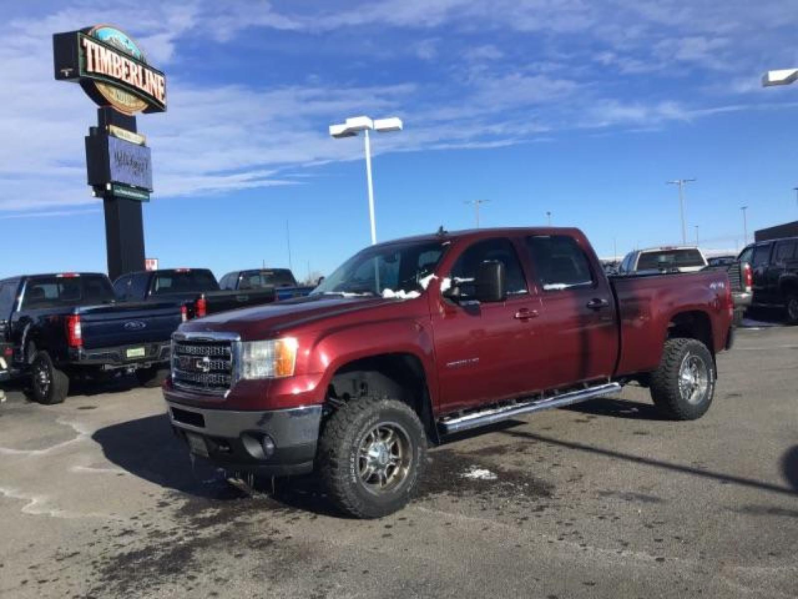 2013 Sonoma Red Metallic /Dark Titanium/Light Titanium Leather Interior GMC Sierra 2500HD SLT Crew Cab 4WD (1GT121C81DF) with an 6.6L V8 OHV 32V TURBO DIESEL engine, 6-Speed Automatic transmission, located at 1235 N Woodruff Ave., Idaho Falls, 83401, (208) 523-1053, 43.507172, -112.000488 - This 2013 GMC Sierra SLT 4x4, has the 6.6L duramax motor. It has 124,000 miles. Comes with leather interior, heated seats, blue tooth, dual power seats, key less remote, and turn over ball. At Timberline Auto it is always easy to find a great deal on your next vehicle! Our experienced sales staff ca - Photo #0