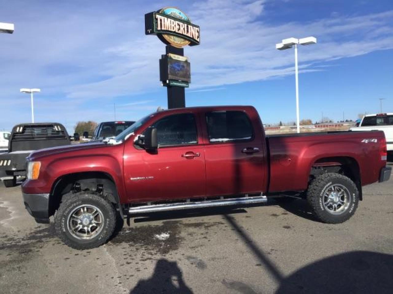 2013 Sonoma Red Metallic /Dark Titanium/Light Titanium Leather Interior GMC Sierra 2500HD SLT Crew Cab 4WD (1GT121C81DF) with an 6.6L V8 OHV 32V TURBO DIESEL engine, 6-Speed Automatic transmission, located at 1235 N Woodruff Ave., Idaho Falls, 83401, (208) 523-1053, 43.507172, -112.000488 - This 2013 GMC Sierra SLT 4x4, has the 6.6L duramax motor. It has 124,000 miles. Comes with leather interior, heated seats, blue tooth, dual power seats, key less remote, and turn over ball. At Timberline Auto it is always easy to find a great deal on your next vehicle! Our experienced sales staff ca - Photo #1