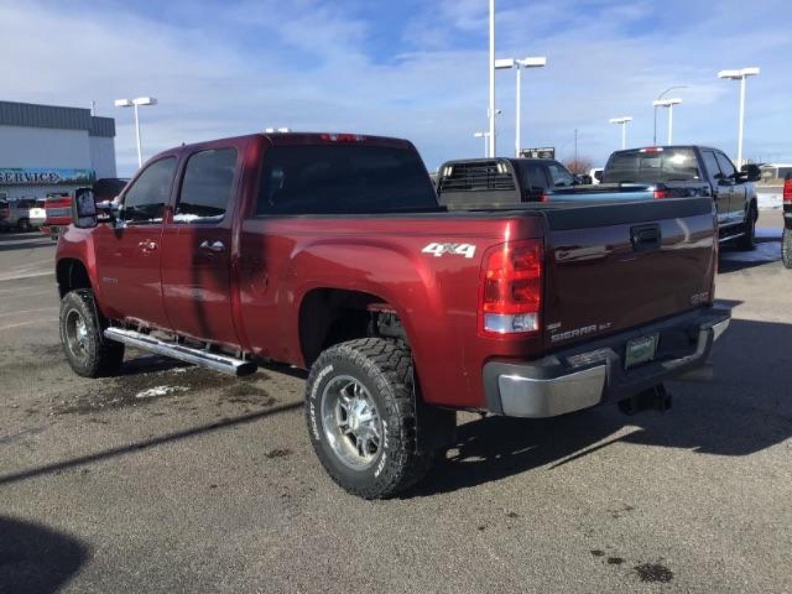 2013 Sonoma Red Metallic /Dark Titanium/Light Titanium Leather Interior GMC Sierra 2500HD SLT Crew Cab 4WD (1GT121C81DF) with an 6.6L V8 OHV 32V TURBO DIESEL engine, 6-Speed Automatic transmission, located at 1235 N Woodruff Ave., Idaho Falls, 83401, (208) 523-1053, 43.507172, -112.000488 - This 2013 GMC Sierra SLT 4x4, has the 6.6L duramax motor. It has 124,000 miles. Comes with leather interior, heated seats, blue tooth, dual power seats, key less remote, and turn over ball. At Timberline Auto it is always easy to find a great deal on your next vehicle! Our experienced sales staff ca - Photo #2