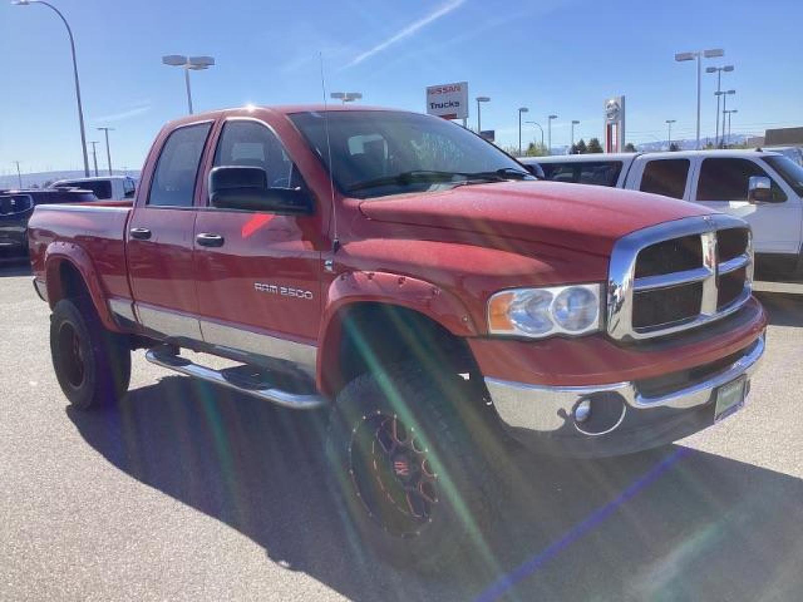 2004 Flame Red /Dark Slate Gray Leather Interior Dodge Ram 2500 SLT Quad Cab 4WD (3D7KU28CX4G) with an 5.9L L6 OHV 24V TURBO DIESEL engine, 5-Speed Automatic transmission, located at 1235 N Woodruff Ave., Idaho Falls, 83401, (208) 523-1053, 43.507172, -112.000488 - The 2004 Dodge Ram 2500 Quad Cab SLT Diesel is a robust and capable truck known for its towing capacity and durability. Here are some of the key features you might find on this model: Engine: Equipped with a powerful and torquey Cummins 5.9-liter inline-six turbocharged diesel engine, known for its - Photo #6