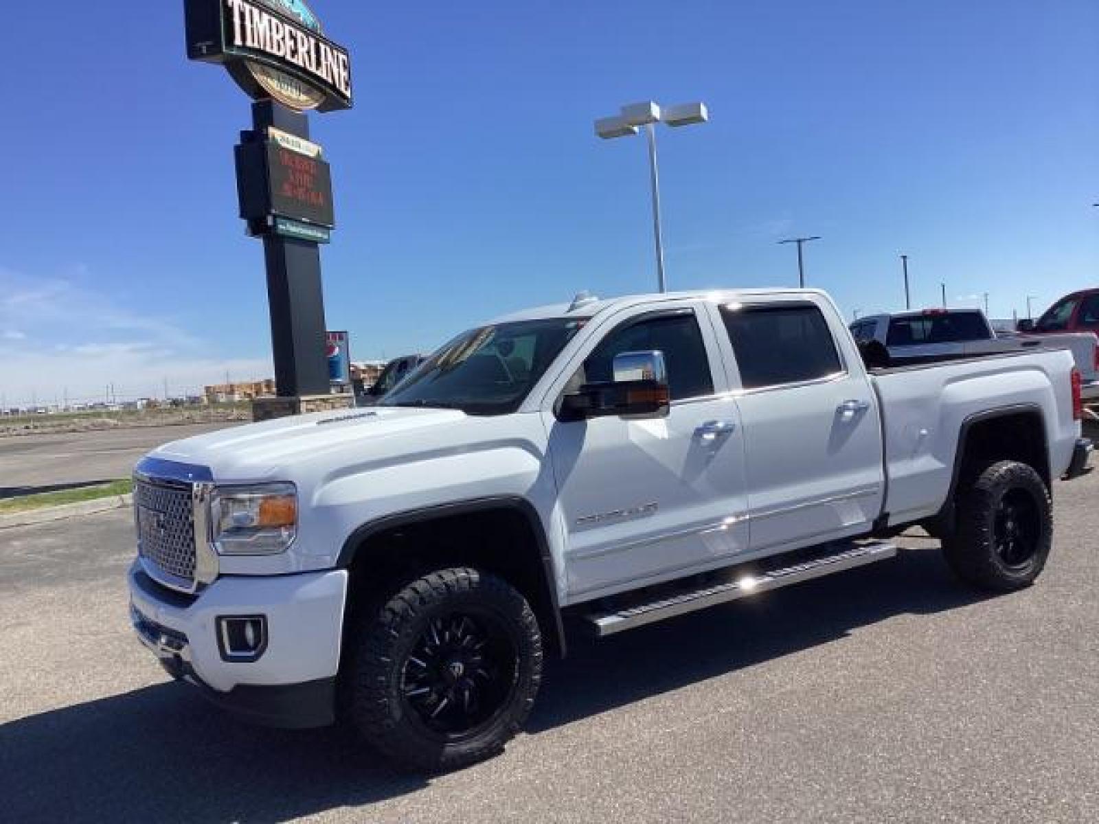 2016 Summit White /Cocoa/Dune, leather GMC Sierra 2500HD Denali Crew Cab 4WD (1GT12UE83GF) with an 6.6L V8 OHV 16 DIESEL engine, 6-Speed Automatic transmission, located at 1235 N Woodruff Ave., Idaho Falls, 83401, (208) 523-1053, 43.507172, -112.000488 - The 2016 GMC Sierra Denali 6.6L typically offers a combination of power, luxury, and capability. Here are some of the key features you can expect to find in this model: Engine: The 6.6-liter V8 turbo diesel engine is one of the standout features of the Sierra Denali. This engine delivers robust per - Photo #0